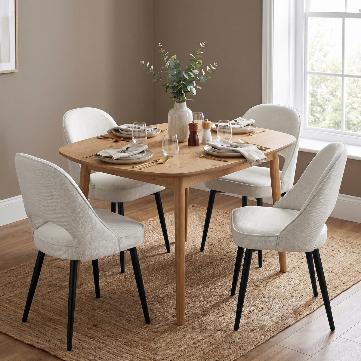 [Cream | Set of 2] Two pairs of the comfy cream dining chairs at a square wood table styled with tableware & vase.