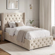 [Single | Beige] Cross ottoman bed side angle with winged tufted headboard and diamond-buttoned base in panelled bedroom