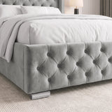 [Double | Light Grey] tufted velvet bed frame with white bedding, shown in a styled bedroom setting with a textured rug and a bedside lamp.