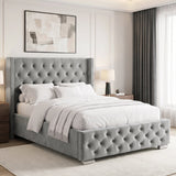 [Double | Light Grey] tufted velvet bed frame with a high wingback headboard and matching footboard, styled in a bright, contemporary bedroom with white bedding, wooden nightstands, and a large window.