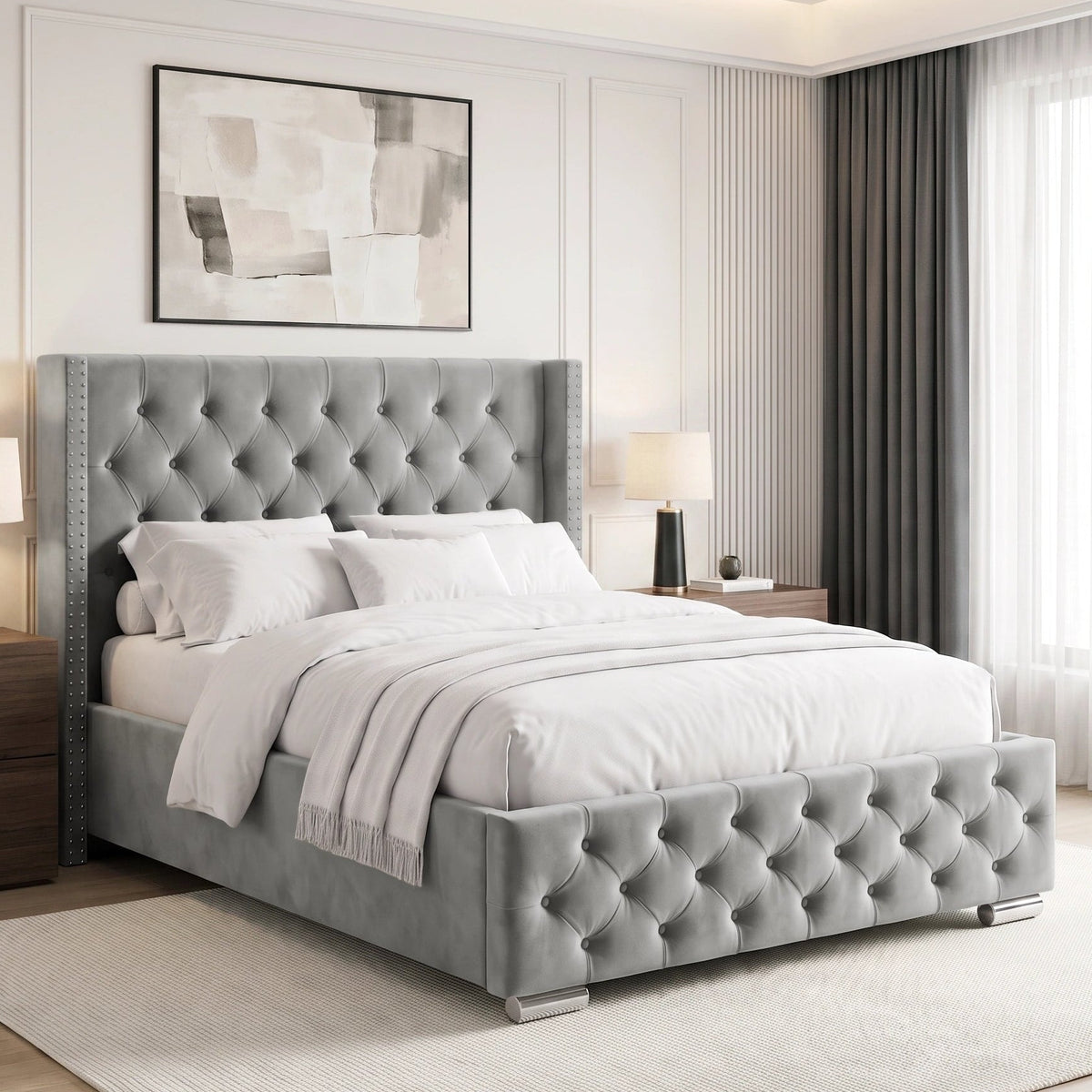[Double | Light Grey] tufted velvet bed frame with a high wingback headboard and matching footboard, styled in a bright, contemporary bedroom with white bedding, wooden nightstands, and a large window.