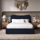 [Double | Blue] Front view of blue boucle double ottoman bed with curved headboard from front in natural day light.