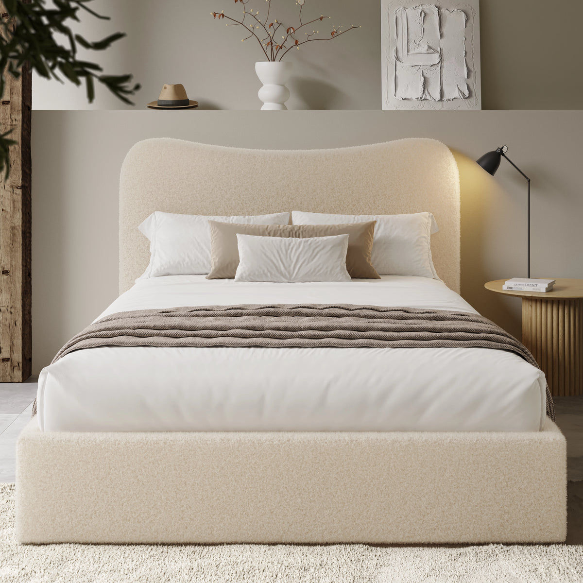 [Double | Beige] Front view of boucle ottoman bed with curved headboard in warm ambient evening lighting