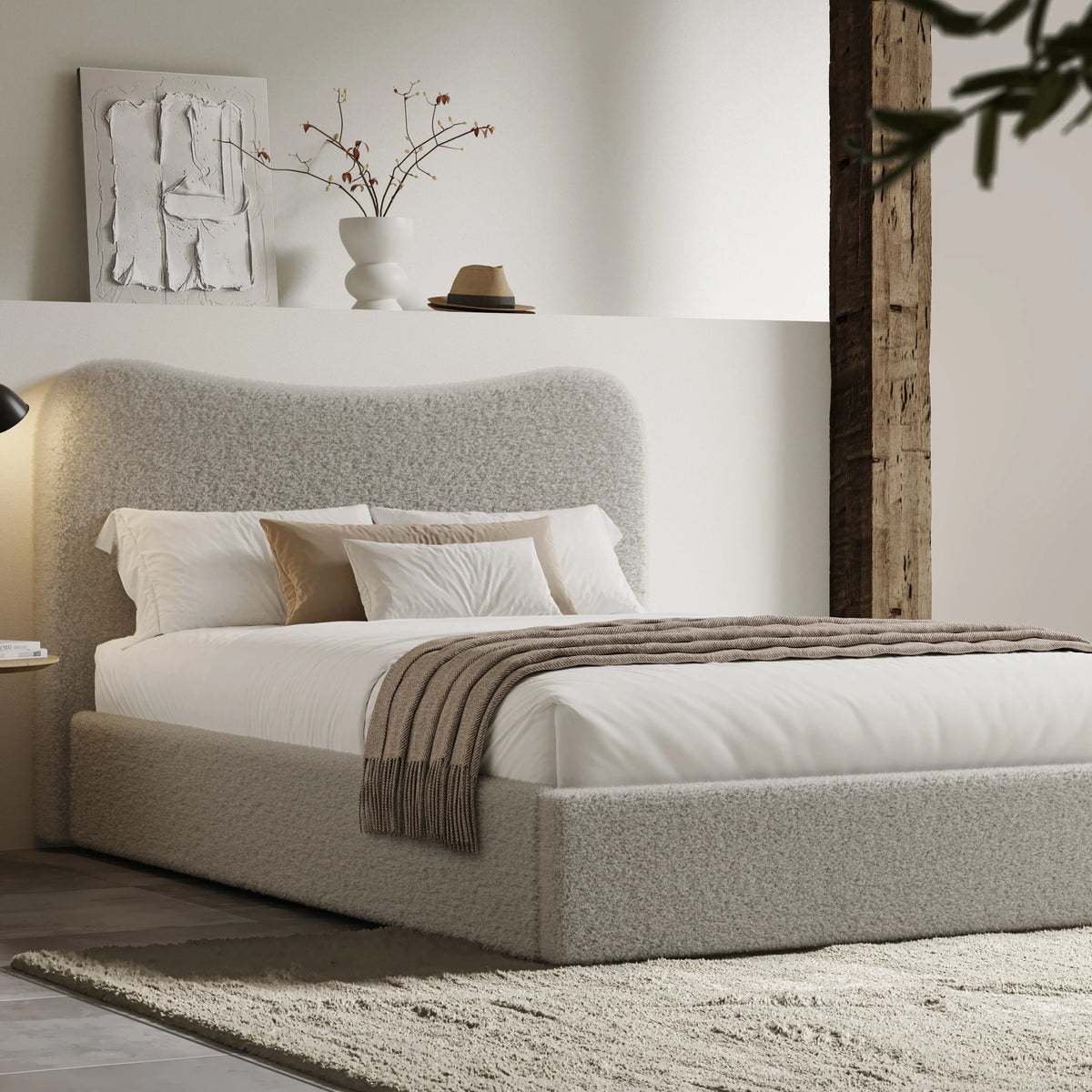 [Double | Grey] Curved headboard ottoman bed in loft-style room with exposed beam and cream shag rug on concrete floor