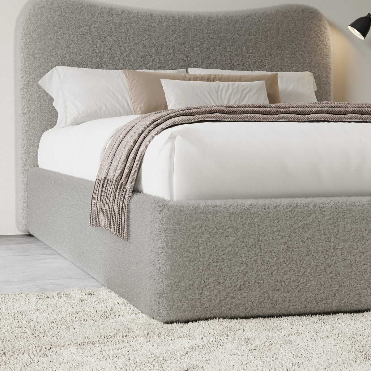 [Double | Grey] Closer view of headboard curve and bedding arrangement with textured boucle fabric visible