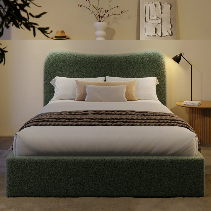 [Double | Sage Green] Front view of boucle ottoman bed with curved headboard in warm ambient evening lighting
