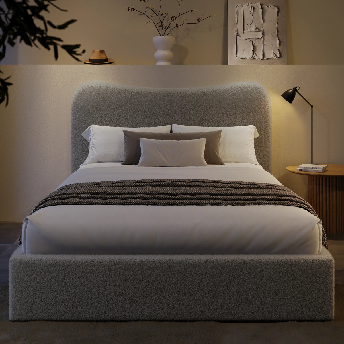 [King | Grey] Front view of boucle ottoman bed with curved headboard in warm ambient evening lighting