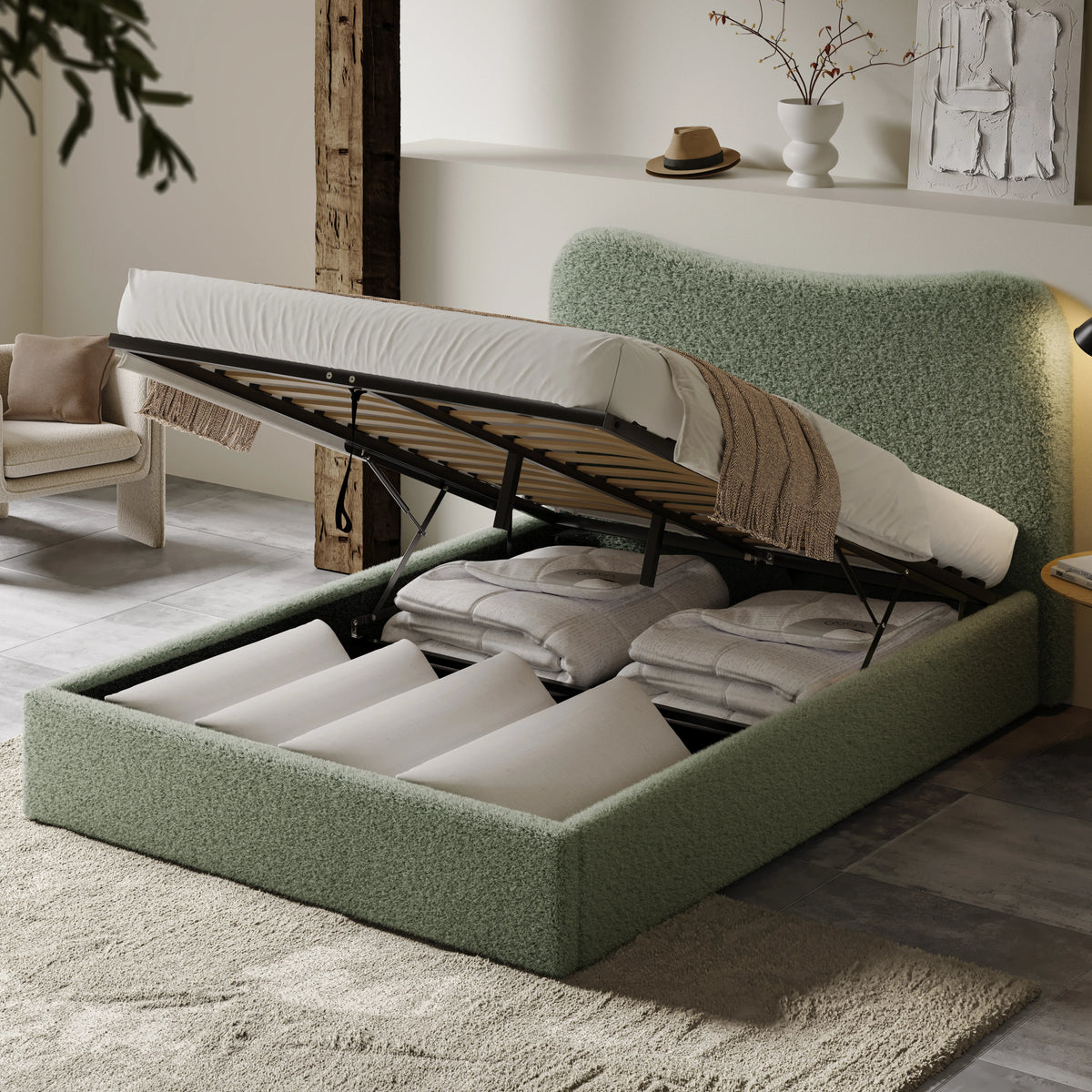 [King | Sage Green] Boucle bed storage compartment exposed with duvets and pillows neatly arranged between divider slats