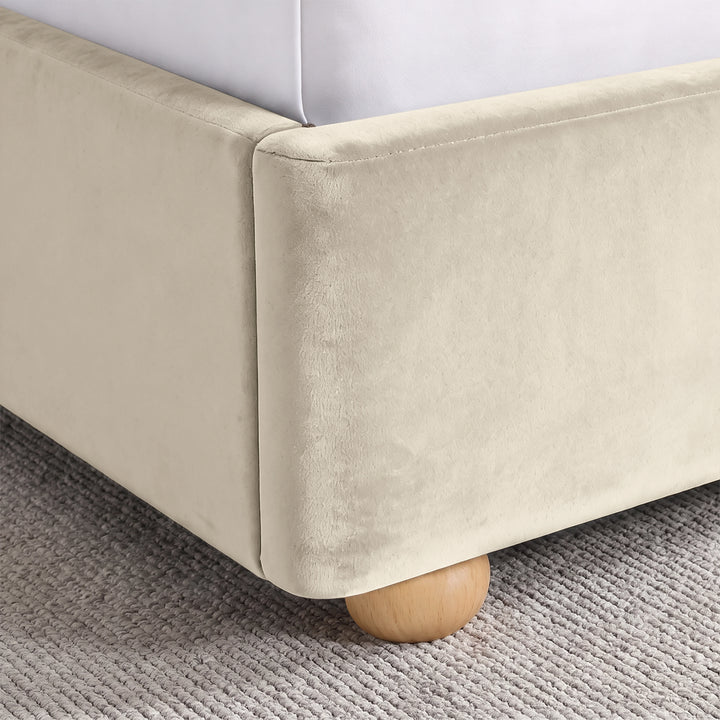 [Beige | Double] Close-up of plush upholstered base corner with rounded solid wood foot and soft curved edge