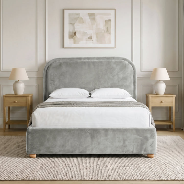 [Light Grey | Double] Curved headboard ottoman bed in light grey plush velvet, front bedroom view with rounded wooden feet