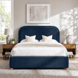 [Blue | King] Curved headboard ottoman bed in blue plush velvet, front bedroom view with rounded wooden feet