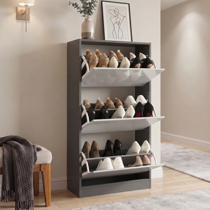 [Dark Grey & Silver Grey] High Gloss 3 Door Shoe Cabinet with all three flip doors open showing three fully loaded tiered racks of heels and flats in a hallway setting