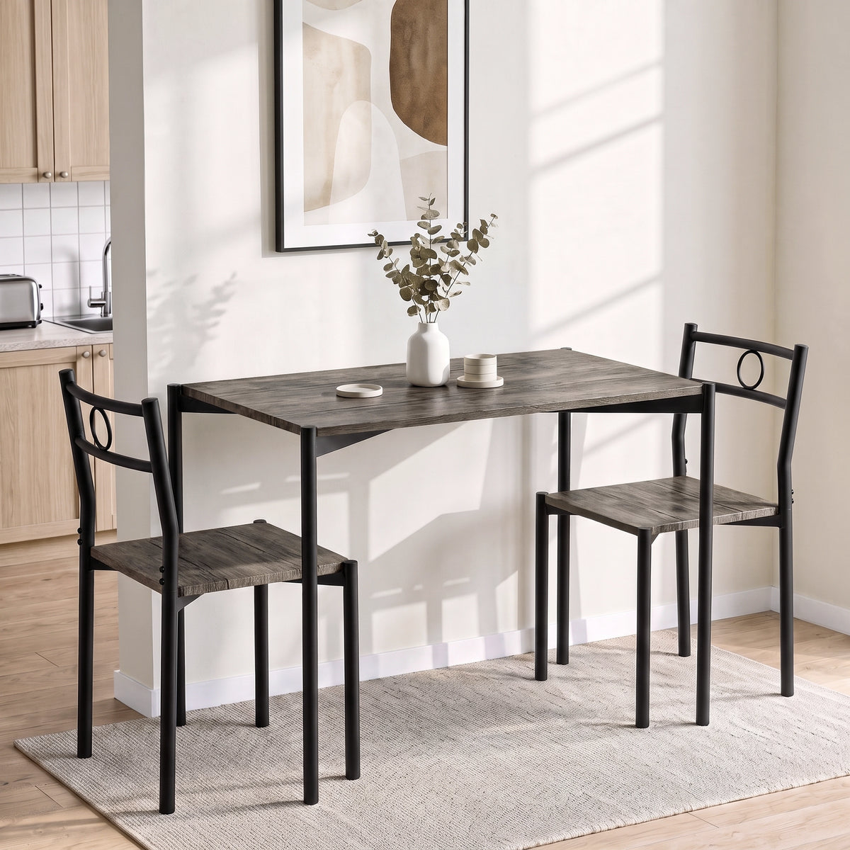 [Dark Wood] Bright kitchen lifestyle view with the two-chair table set, white mugs, coasters and a vase on the tabletop