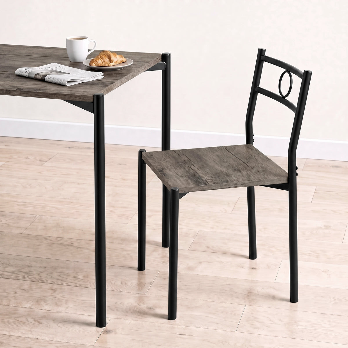 [Dark Wood] Close-up showing the tabletop edge, chair seat, black round-pipe legs, circular chair back, mug and croissant