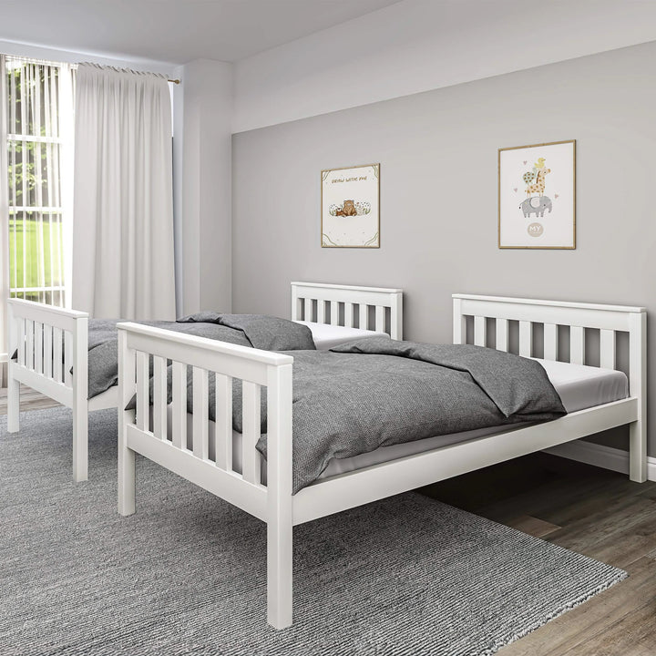 [White] split configuration of white double bunk bed forming two single beds against grey wall with white curtains