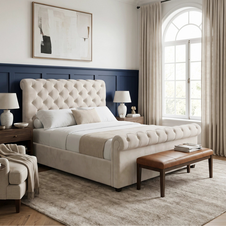[Double | Beige] Styled room view with rolled footboard, bench, armchair, tall arched window, curtains, and textured rug