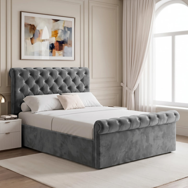 [Double | Dark Grey] Angled bedroom view with tufted headboard, rolled footboard, bedside table, wall art, and tall window