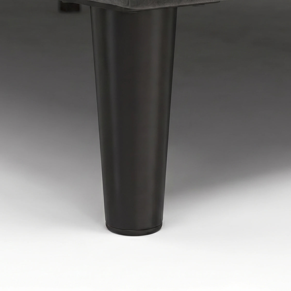 [Double | Grey] Velvet Bed Frame close-up of single black tapered solid wood leg on plain background