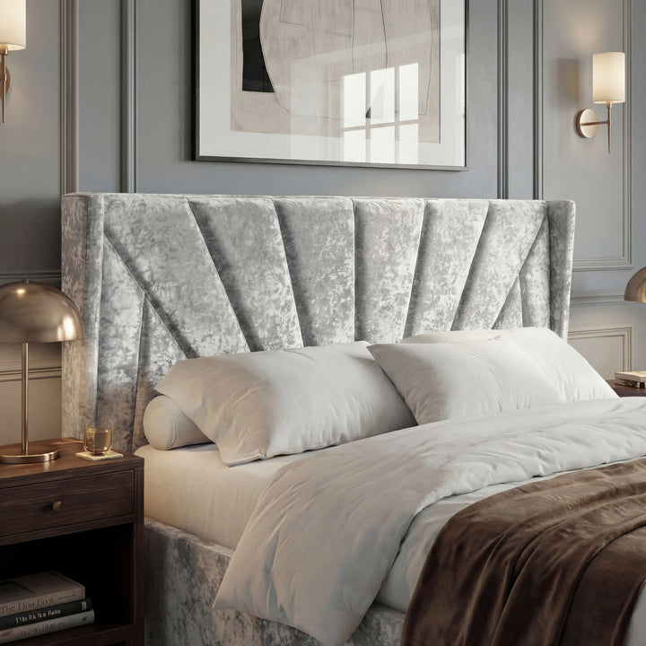 [Double | Silver] Close view of Sunrise wing headboard with pleated panels, pillows, and brass bedside lamp