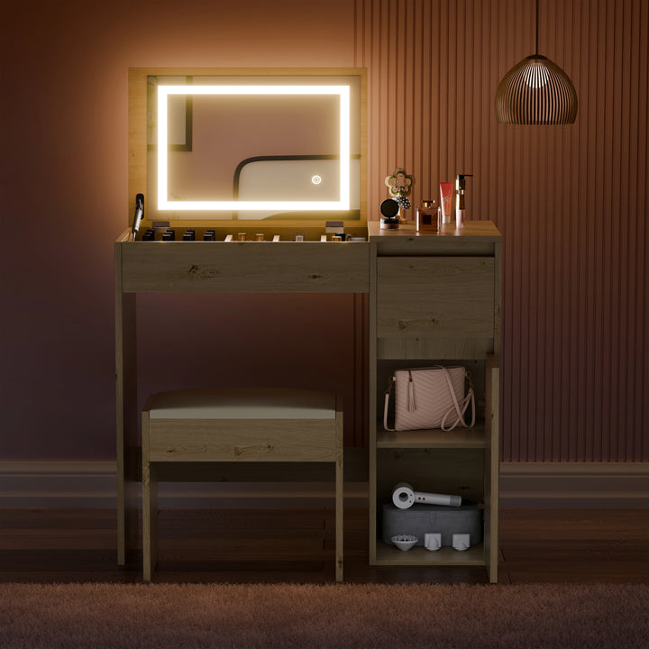 [Oak] front view oak vanity with lit mirror, perfumes and brushes on top, handbag on side shelf