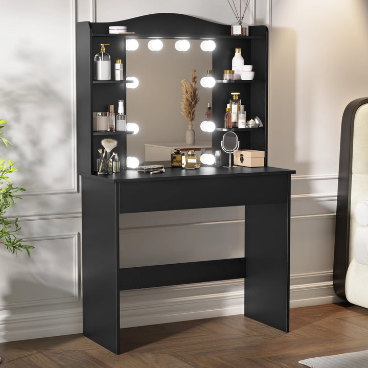 [Black] makeup vanity in black, Hollywood mirror with row of bulbs lit, shelves of perfumes and pampas