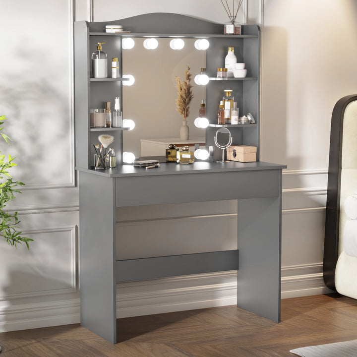 [Grey] makeup vanity in grey, lit mirror with bulbs, shelves of cosmetics and dried wheat stems, white wall
