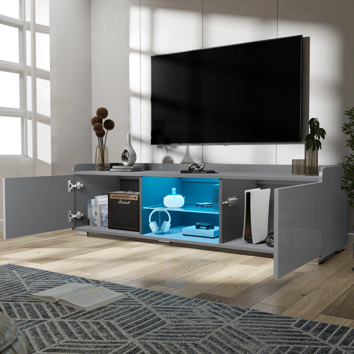 [Grey] grey TV unit doors-open lifestyle with vase, books on top and yellow glow from inside
