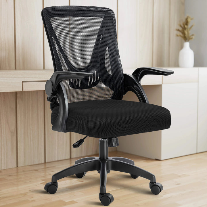 [Black] In a home office setup, the black mesh chair is positioned with a working desk in the backdrop for ergonomic seating.