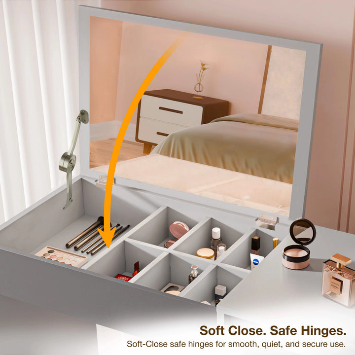 [Grey] Close-up of dressing table lid with orange arrow indicating soft-close hinge motion