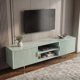 [Sage Green] Wide-angle sage green 180cm TV unit lifestyle, TV mounted, vase of green foliage on top left, brass legs on rug.