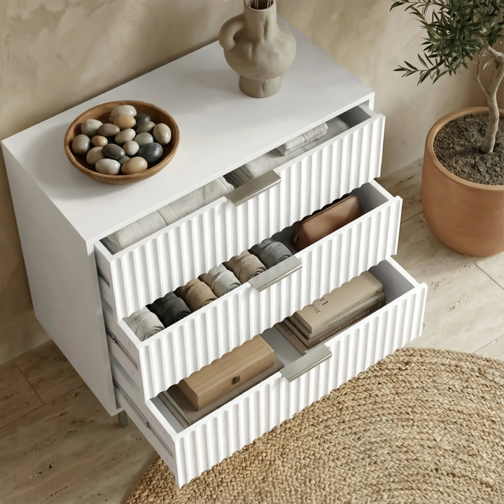 [White] Flutrina 3 drawer chest with all drawers stepped open showing internal storage from above