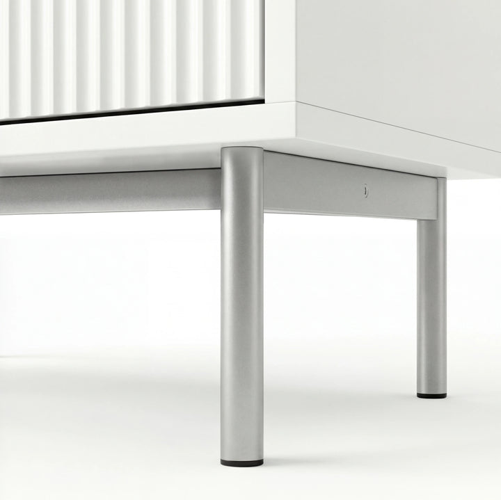 [White] flutrina chest of drawers underside view of the silver metal legs and connecting front frame