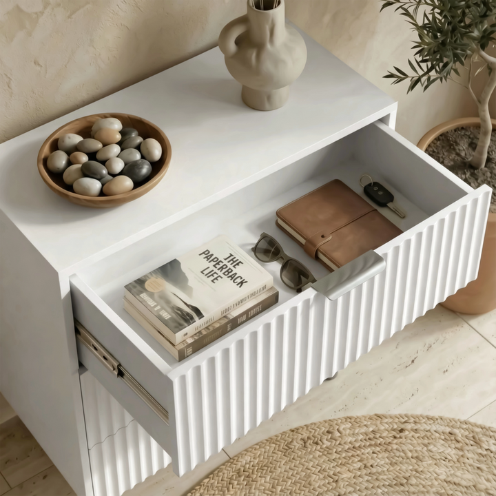 [White] Flutrina 3 drawer chest with only the top drawer pulled open, holding a leather notebook and magazine