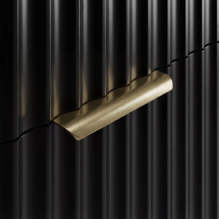 [Black] Gold metal handle detail on a black flutrina chest of drawers front with vertical sturdy panel design