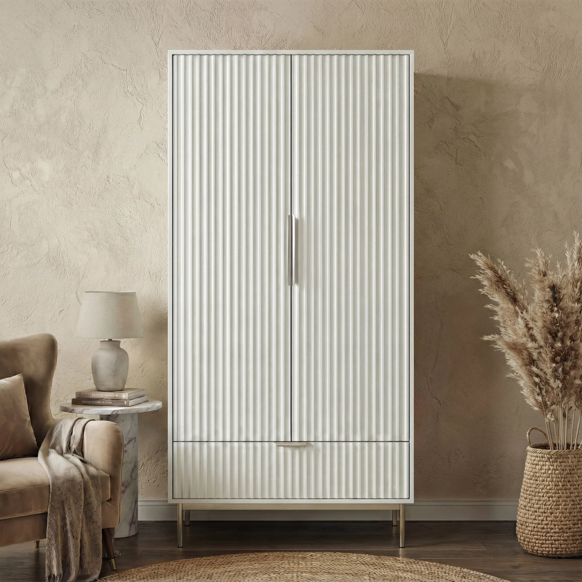 [White] Freestanding white wardrobe with drawer placed in softly lit room with neutral walls and minimal decor