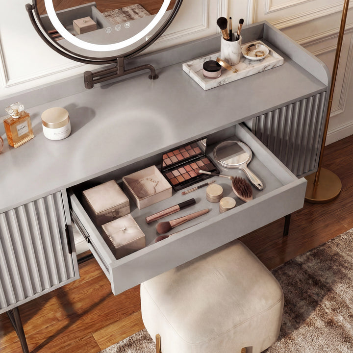 [Grey] open-cabinet detail of the grey dressing table showing shelves of perfumes, books and a basket