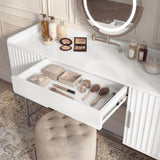 [White]  vanity makeup table with a drawer open, showcasing neatly arranged beauty products and accessories
