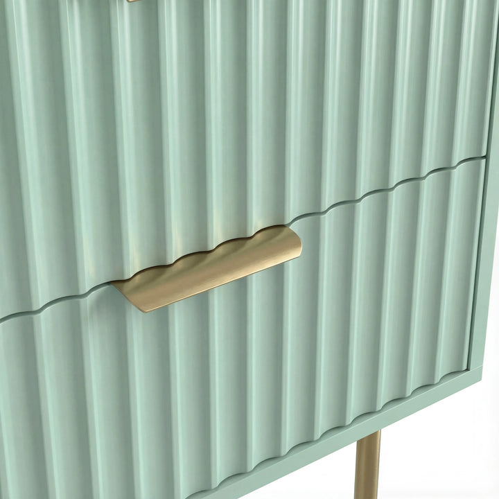 [Sage Green] Close detail of the golden metallic handle fixed to the green flutrina design drawer surface of a nightstand