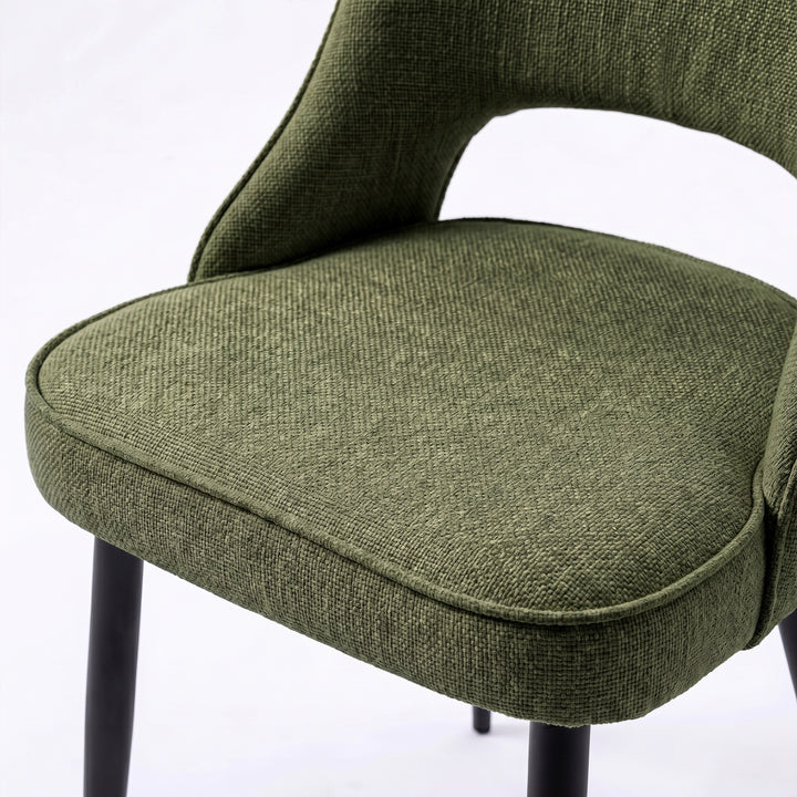 [Green | Set of 2]  Comfy dining chair close-up of fabric seat, piped edge, curved open back and black metal legs.