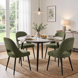 [Green | Set of 4]  Four comfortable dining chairs around a round table styled with plates, glasses, fruit and a vase.