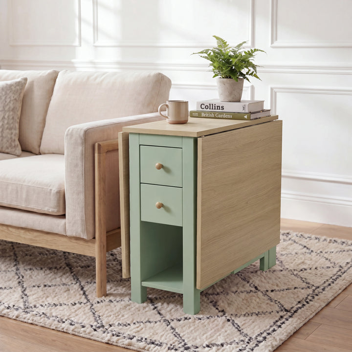 [150cm | Green] Stovra Drop Leaf Dining Table used as a side table beside a sofa with one leaf extended and plant on top