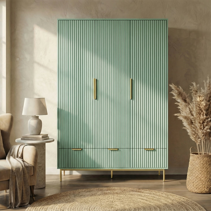 [Sage Green] three door freestanding wardrobe with gold handles and legs, placed in a natural light room