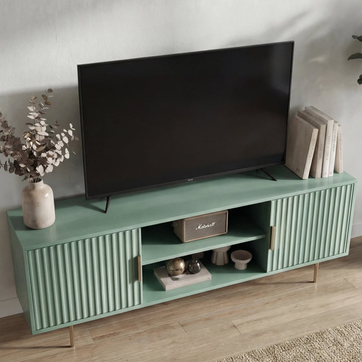 [Sage Green]  Sage green Flutrina TV media unit angled right, ribbed doors flank centre shelf with Marshall speaker and bowl