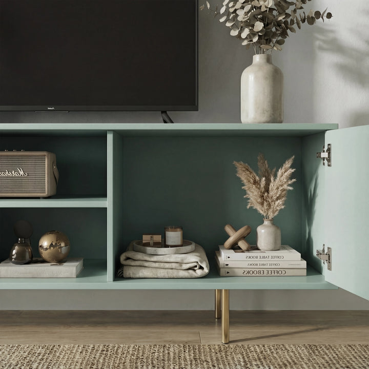 [Sage Green]  Interior of sage green Flutrina TV unit, both ribbed doors open showing rattan speaker, gold ball and pampas vase