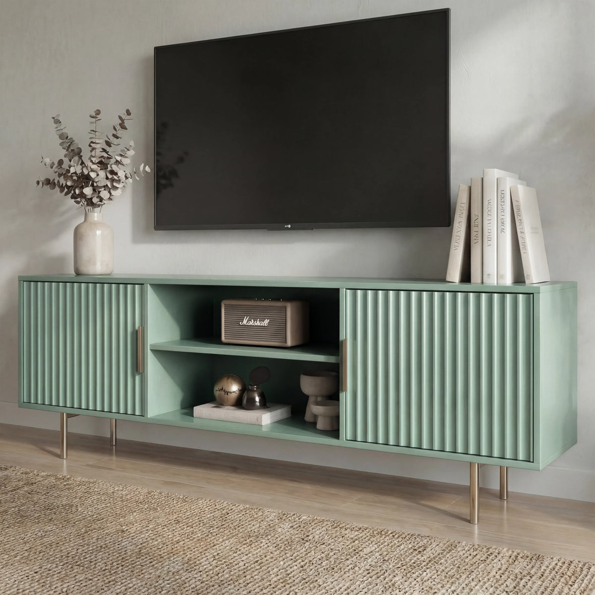 [Sage Green]  Sage green TV unit shot from the side, fluted door texture and gold legs, dried branches in vase on top