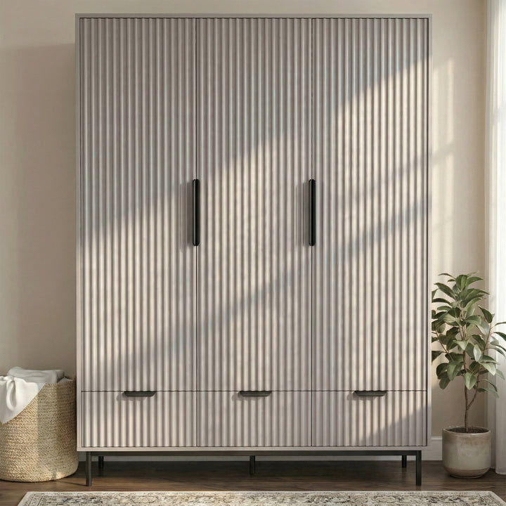 [Grey] three door wardrobe with drawers styled in modern room with neutral walls and lighting