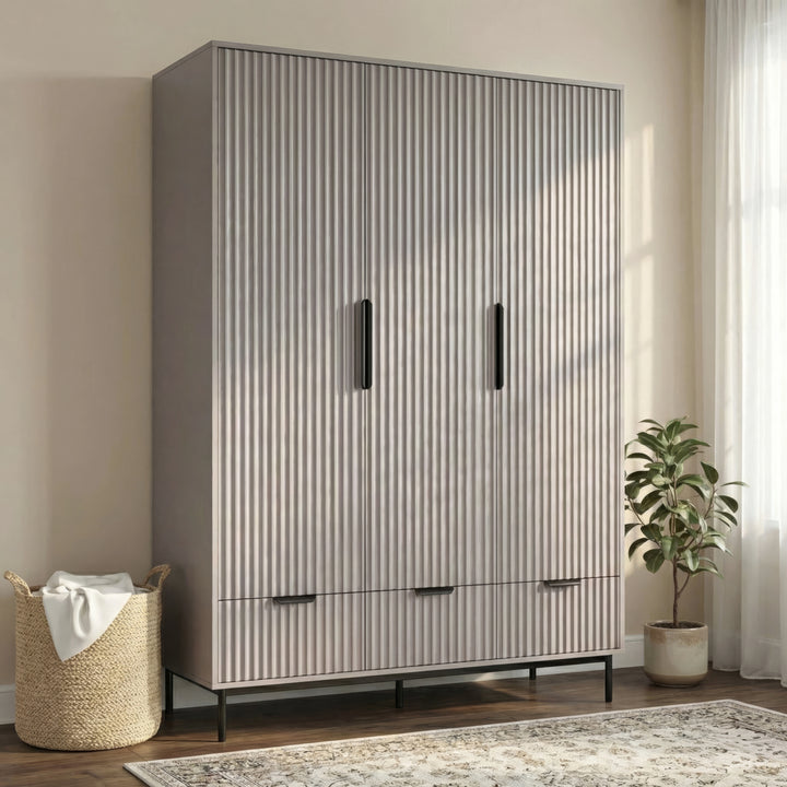 [Grey] three door wardrobe with drawers styled in modern room with neutral walls and lighting