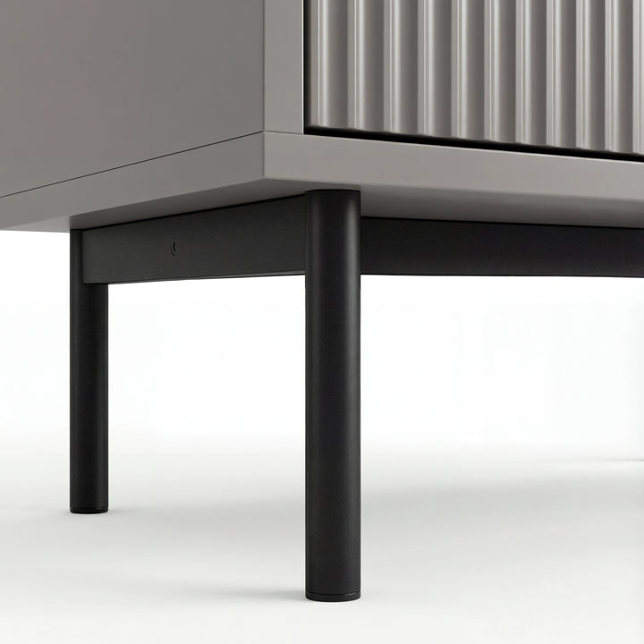 [Grey] Lower section of grey 5 chest of drawers with black metal legs and corner of the cabinet base