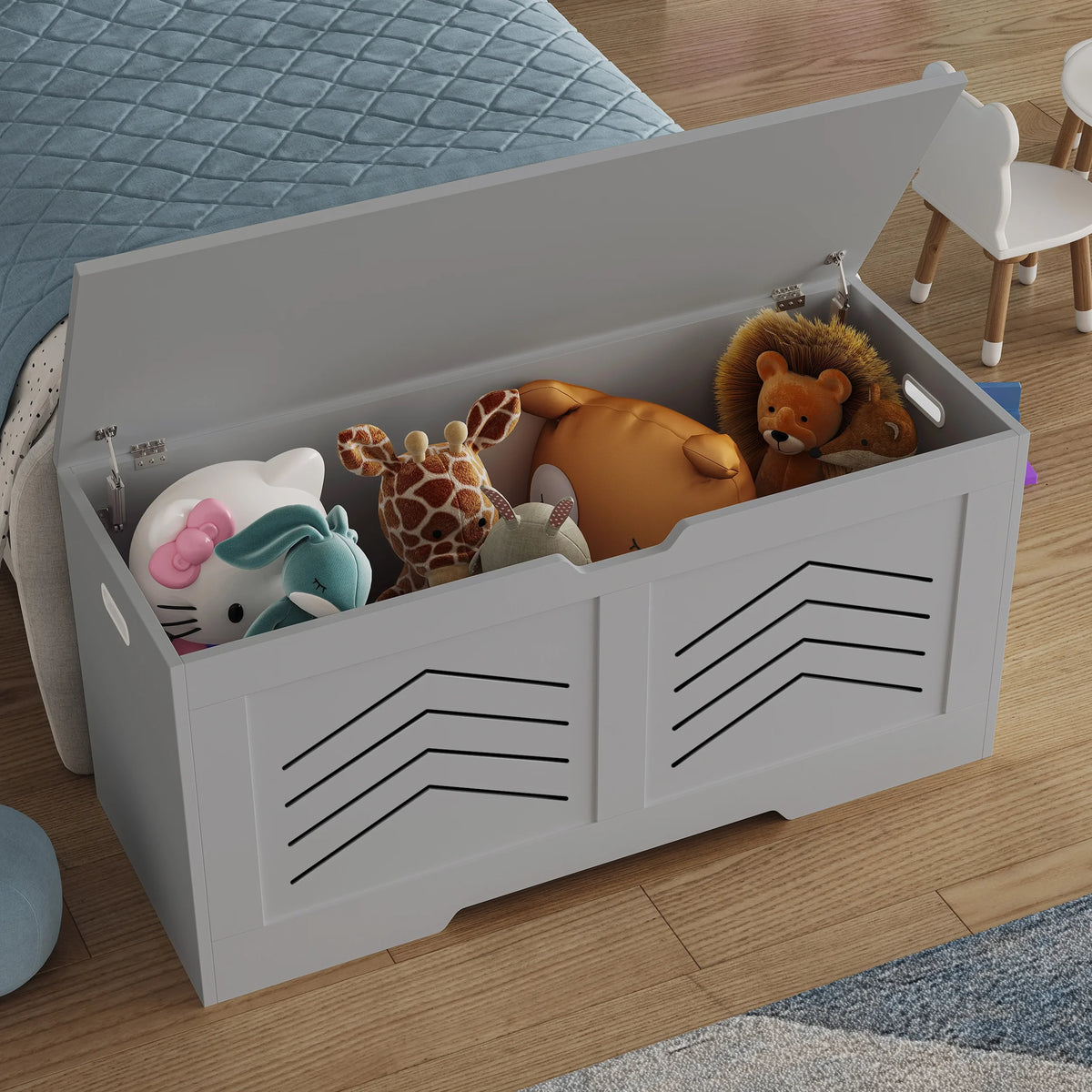 [Grey] Grey toy storage box with black patterns filled with stuffed animals on a wooden floor.
