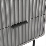 [Grey] Close detail of the black metallic handle fixed to the grey flutrina design drawer surface of a nightstand